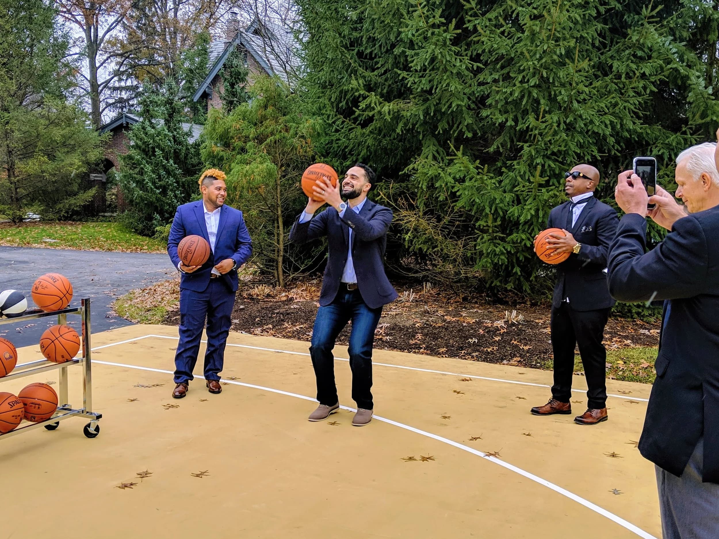 Justin Steele mid-shot at the Indiana Governor’s court, MC Hammer holding a basketball — The Last Mile launch, December 2018